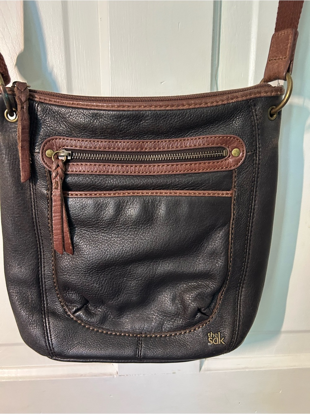 The Sak Black Leather Crossbody with Brown Trim and Tassel